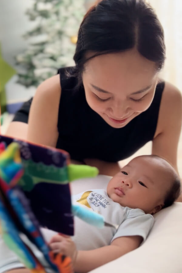 Home MY 17 Blissbies baby looking at our interactive book with mum